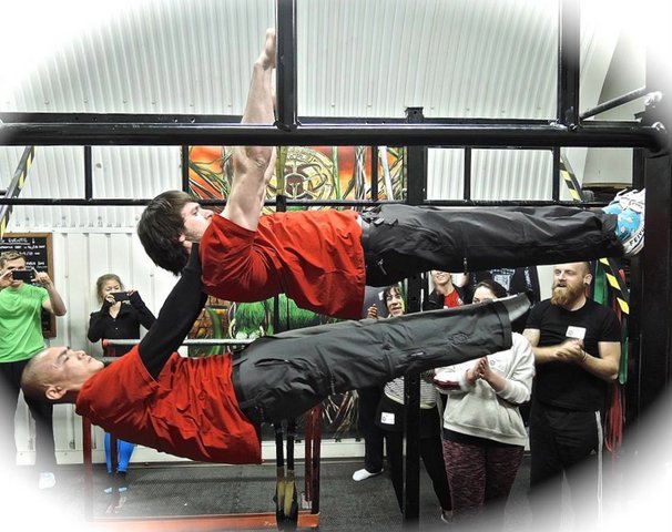 Double front lever performed by PCC instructors Fitsz Dubova and Coung Hua from the Commando Temple.